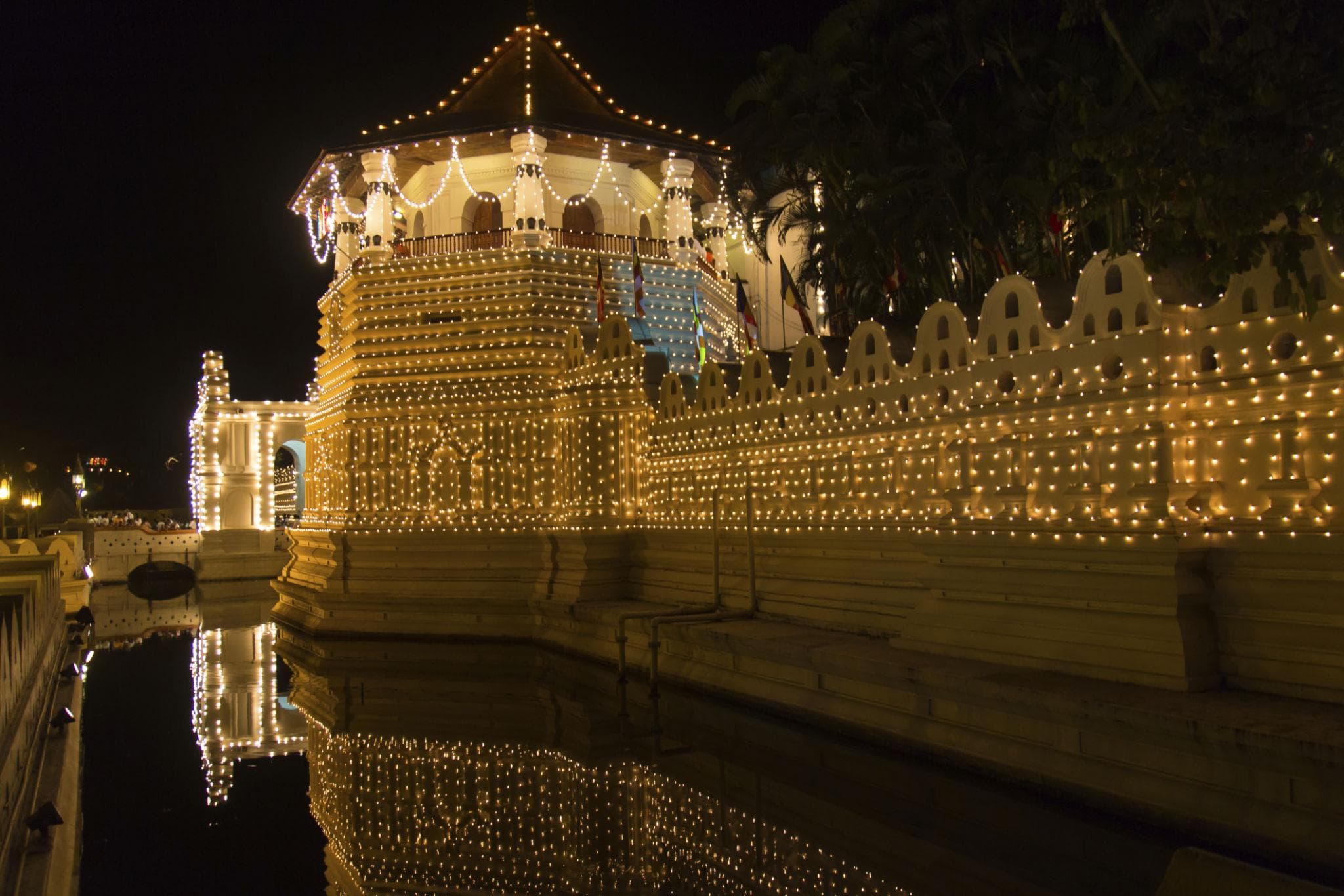 Ornate temple architecture and tropical greenery in Kandy, Sri Lanka